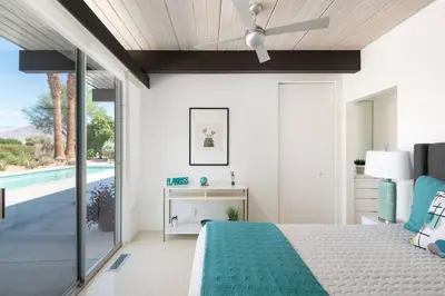a bedroom with a bed and a swimming pool at The Milky Way Modern Desert Retreat in Borrego Springs
