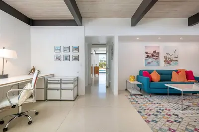 a living room with a blue couch and a table at The Milky Way Modern Desert Retreat in Borrego Springs