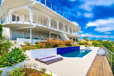 a house with a swimming pool in front of it at La Jolla Paradise with Ocean Views Pool and Spa in San Diego