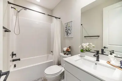 a bathroom with a sink and a toilet and a tub at #Marbella Lane - Elegant 5BR Home Rancho Mission in Ladera Ranch