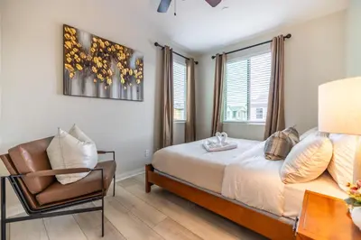 a bedroom with a bed and a chair at #Marbella Lane - Elegant 5BR Home Rancho Mission in Ladera Ranch