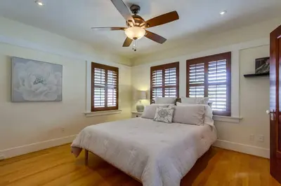 a bedroom with a bed and a ceiling fan at Cozy Craftsman Bungalow, Hillcrest/Mission Hills in San Diego