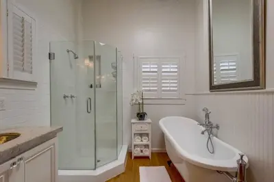 a white bathroom with a shower and a sink at Cozy Craftsman Bungalow, Hillcrest/Mission Hills in San Diego