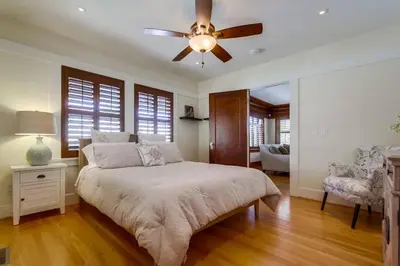 a bedroom with a bed and a ceiling fan at Cozy Craftsman Bungalow, Hillcrest/Mission Hills in San Diego