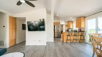 an open kitchen with wooden cabinets and a counter top at Home Ensuite with Panoramic City View in San Diego