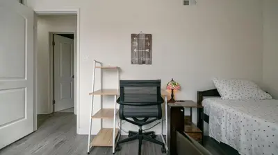 a bedroom with a desk and a chair next to a bed at Home Ensuite with Panoramic City View in San Diego