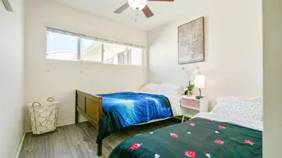 a bedroom with two beds and a window at Home Ensuite with Panoramic City View in San Diego