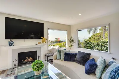 a living room with a couch and a fireplace at Laguna Beach Escape with Hot Tub and Ocean Views! in Laguna Beach