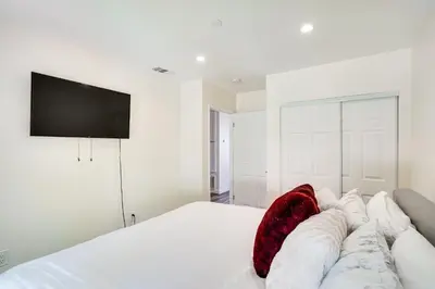 a bedroom with a bed with a television on the wall at Laguna Beach Escape with Hot Tub and Ocean Views! in Laguna Beach