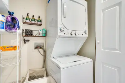 a white washer and dryer in a small bathroom at Laguna Beach Escape with Hot Tub and Ocean Views! in Laguna Beach
