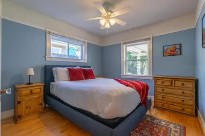 a bedroom with a bed and a ceiling fan at North Park Sanctuary in San Diego