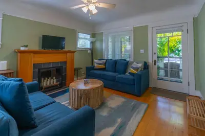 a living room with blue couches and a fireplace at North Park Sanctuary in San Diego