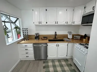 a kitchen with white cabinets and a sink at Beachside 2BR close 2 sand, town in Laguna Beach
