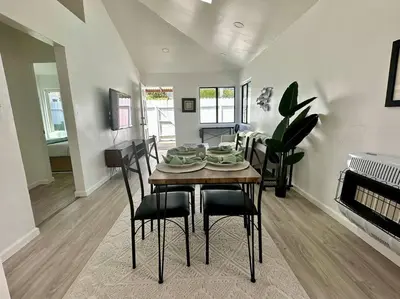 a dining room and living room with a table and chairs at Beachside 2BR close 2 sand, town in Laguna Beach