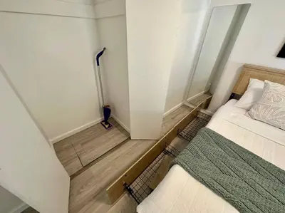a small bedroom with a bed and a broom at Beachside 2BR close 2 sand, town in Laguna Beach