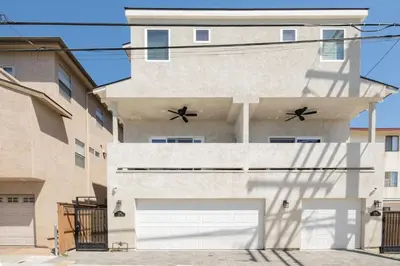 a building with two garage doors in front of it at 4048 Stylish condo in Hillcrest Mission Hills in San Diego
