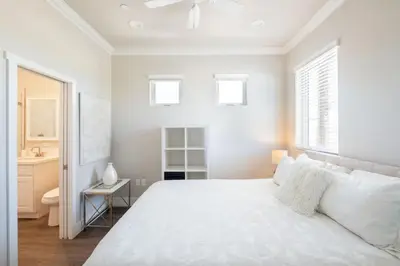 a white bedroom with a large bed and a sink at 4046 Modern condo in Hillcrest Mission Hills in San Diego