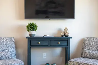 a blue table with a plant on it next to two chairs at 4046 Modern condo in Hillcrest Mission Hills in San Diego