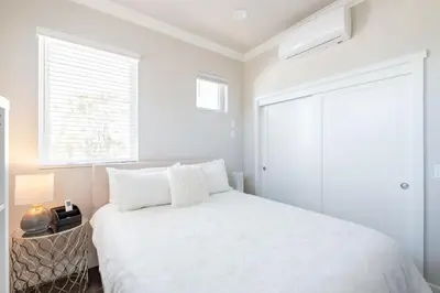 a white bedroom with a bed and a window at 4046 Modern condo in Hillcrest Mission Hills in San Diego