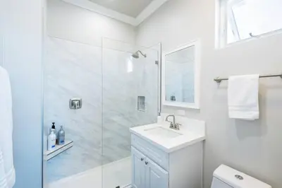 a white bathroom with a shower and a sink at 4046 Modern condo in Hillcrest Mission Hills in San Diego