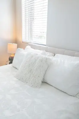 a white bed with white pillows and a window at 4046 Modern condo in Hillcrest Mission Hills in San Diego