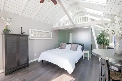 a bedroom with a white bed and a table at 4221 Urban oasis in Hillcrest Mission Hills in San Diego
