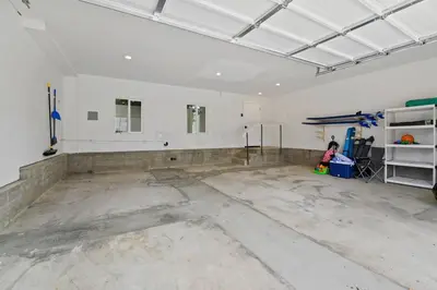 an empty garage with a large room with white walls at Saratoga Sunset - Rooftop - Sleek - Walk to Beach in San Diego