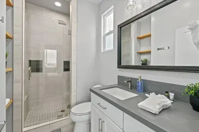 a bathroom with a toilet and a sink and a shower at Saratoga Sunset - Rooftop - Sleek - Walk to Beach in San Diego