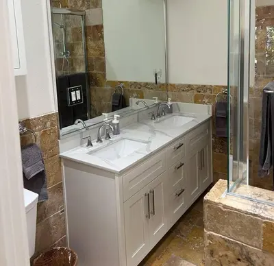 a bathroom with two sinks and a large mirror at laguna beach cottage home in Laguna Beach