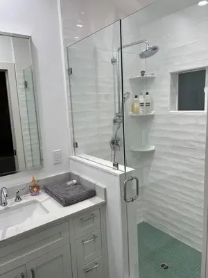 a white bathroom with a shower and a sink at laguna beach cottage home in Laguna Beach