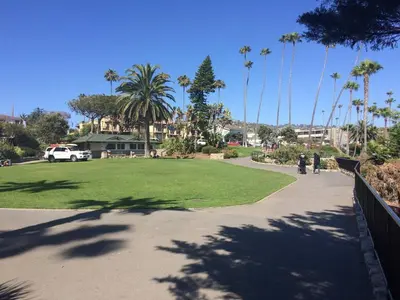 a park with palm trees and a walkway at laguna beach cottage home in Laguna Beach