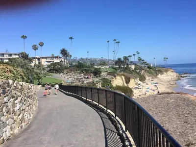 a group of people walking on a bridge near the beach at laguna beach cottage home in Laguna Beach