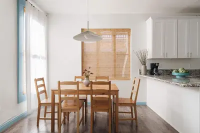 a dining room with a wooden table and chairs at Victorian Retreat in Barrio Logan 1mi to Downtown in San Diego