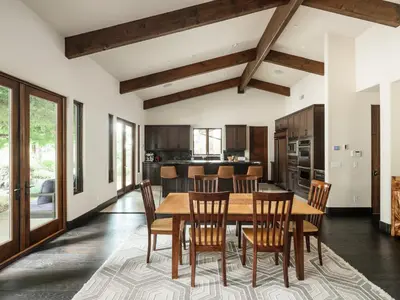 a dining room and kitchen with a wooden table and chairs at Private Resort in Lake Hodges in Escondido