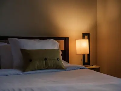 a bedroom with a bed with a pillow and a lamp at Private Resort in Lake Hodges in Escondido