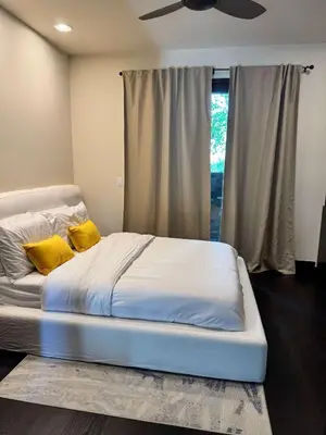 a bed with two yellow pillows in a bedroom at Private Resort in Lake Hodges in Escondido