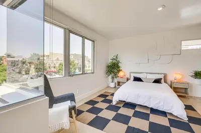 a bedroom with a bed and a large window at Rooftop with Views Modern Little Italy Townhome in San Diego