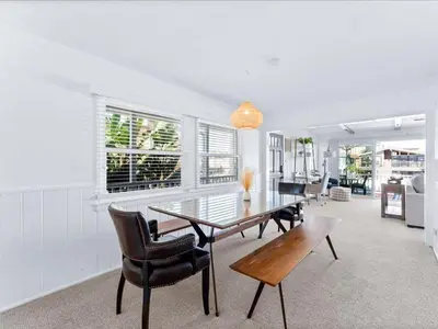 a dining room with a glass table and chairs at Stunning Bayfront Home w Epic Dock on Peninsula in Newport Beach