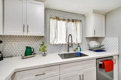 a kitchen with white cabinets and a sink at San Diego Condo Pool Access, 8 Mi to Downtown in San Diego