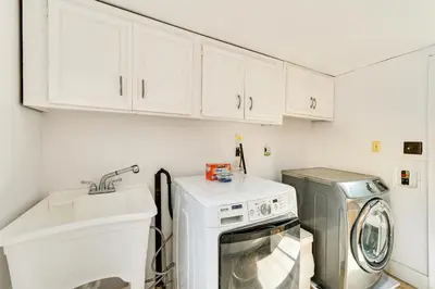 a kitchen with a washing machine and a sink at Sunny San Diego Home with Private Yard and Grill! in San Diego