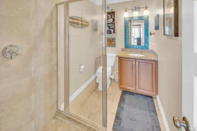 a bathroom with a shower and a toilet and a sink at Seaview 1135A in Oceanside