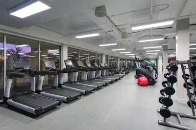 a gym with rows of treadmills and machines at Luxurious stay near the beach in Newport Beach