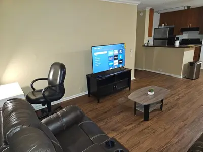 a living room with a couch and a flat screen tv at Luxurious stay near the beach in Newport Beach