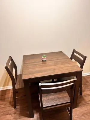 a wooden table with two chairs and a plant on it at Luxurious stay near the beach in Newport Beach