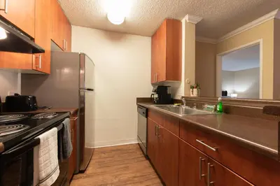 a kitchen with wooden cabinets and a stainless steel refrigerator at Luxurious stay near the beach in Newport Beach