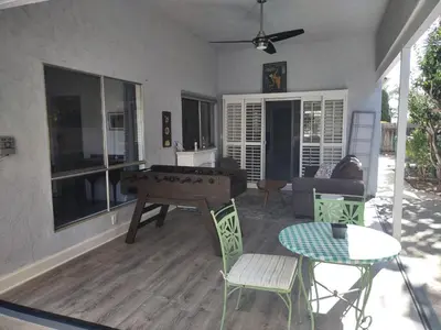 a living room with a ping pong table and chairs at Custom Home - Beach close/convenient to everything in Oceanside