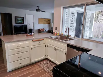 a kitchen with a sink and a large window at Custom Home - Beach close/convenient to everything in Oceanside