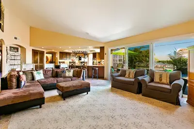 a large living room with couches and a kitchen at WesternWhiteHouseSC in San Clemente