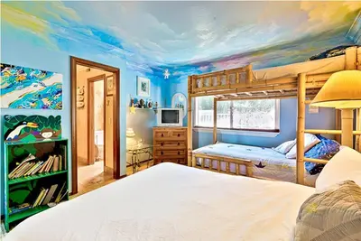 a bedroom with two bunk beds and a painting of a unicorn at WesternWhiteHouseSC in San Clemente