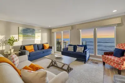 a living room with blue couches and the ocean at Seaview 1133A in Oceanside